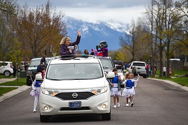 Rankin Elementary Principal Merisa Murray leads a parade of teachers and staff through the neighborhood along Bluestone Drive in Kalispell on Thursday, May 7. (Casey Kreider/Daily Inter Lake)