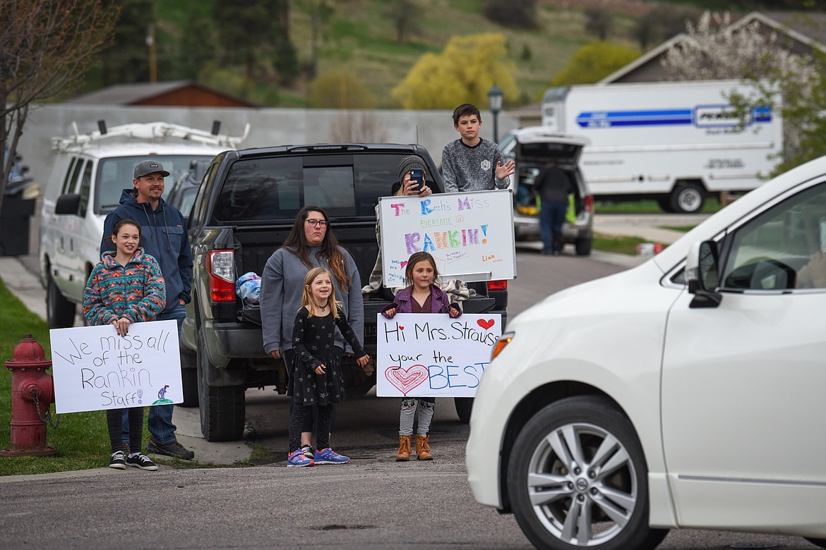 Families hold signs during a parade of Rankin Elementary School teachers and staff through the neighborhood along Bluestone Drive in Kalispell on Thursday, May 7. Schools have been closed since March due to COVID-19 and students learning remotely at home. (Casey Kreider/Daily Inter Lake)