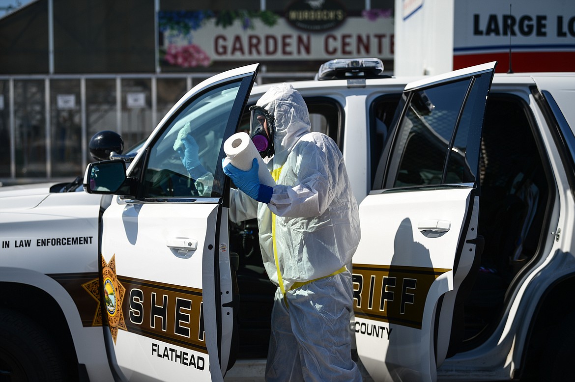 Workers with Dayspring Restoration sanitize a Flathead County Sheriff’s vehicle outside Murdoch’s Ranch & Home Supply in Kalispell on Thursday. Dayspring provided free, hospital-grade disinfection to any city and county vehicles from noon to 5 p.m. in response to the COVID-19 pandemic. (Casey Kreider/Daily Inter Lake)