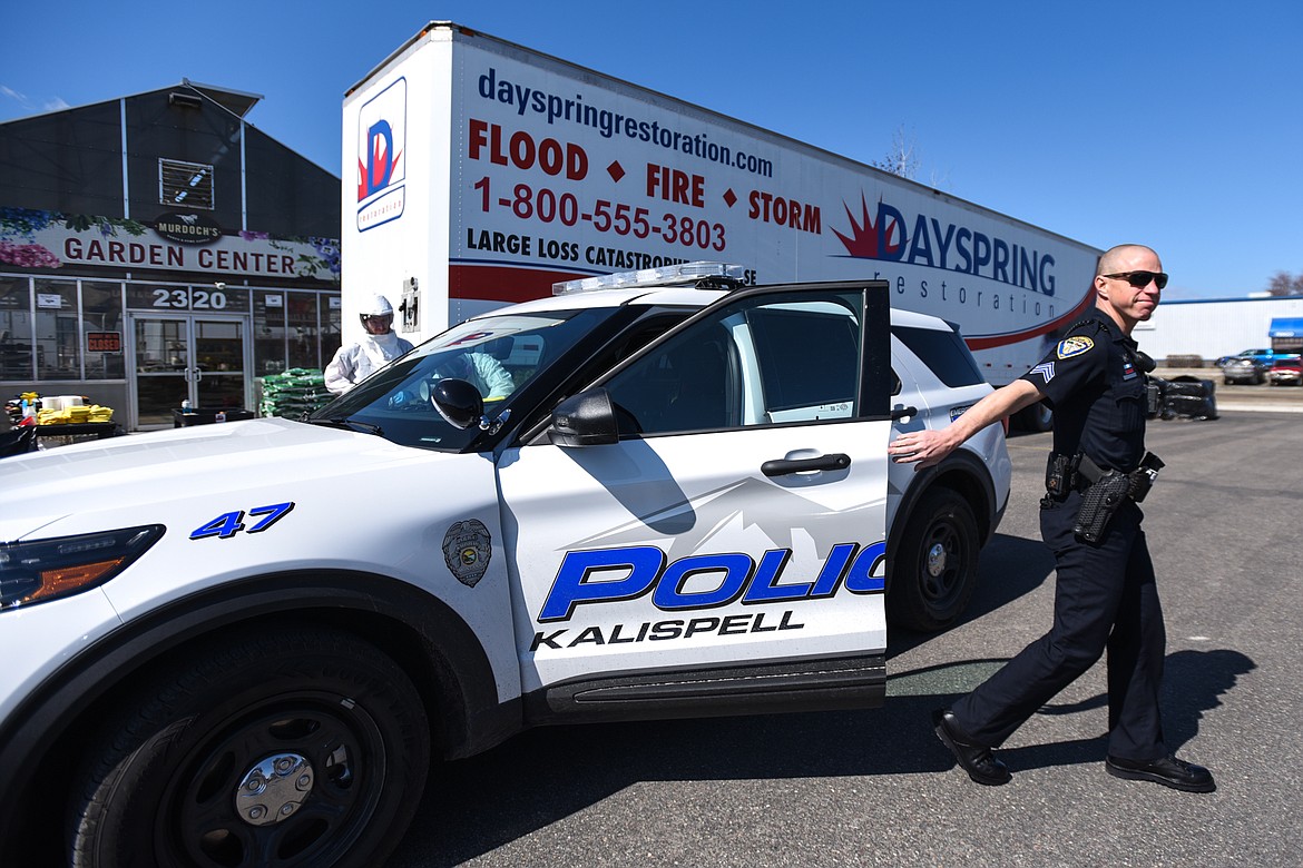 Kalispell police officer Chad Fetveit arrives to get his vehicle sanitized by Dayspring Restoration Workers outside Murdoch’s Ranch & Home Supply in Kalispell on Thursday. Dayspring provided free, hospital-grade disinfection to any city and county vehicles from noon to 5 p.m. in response to the COVID-19 pandemic. (Casey Kreider/Daily Inter Lake)