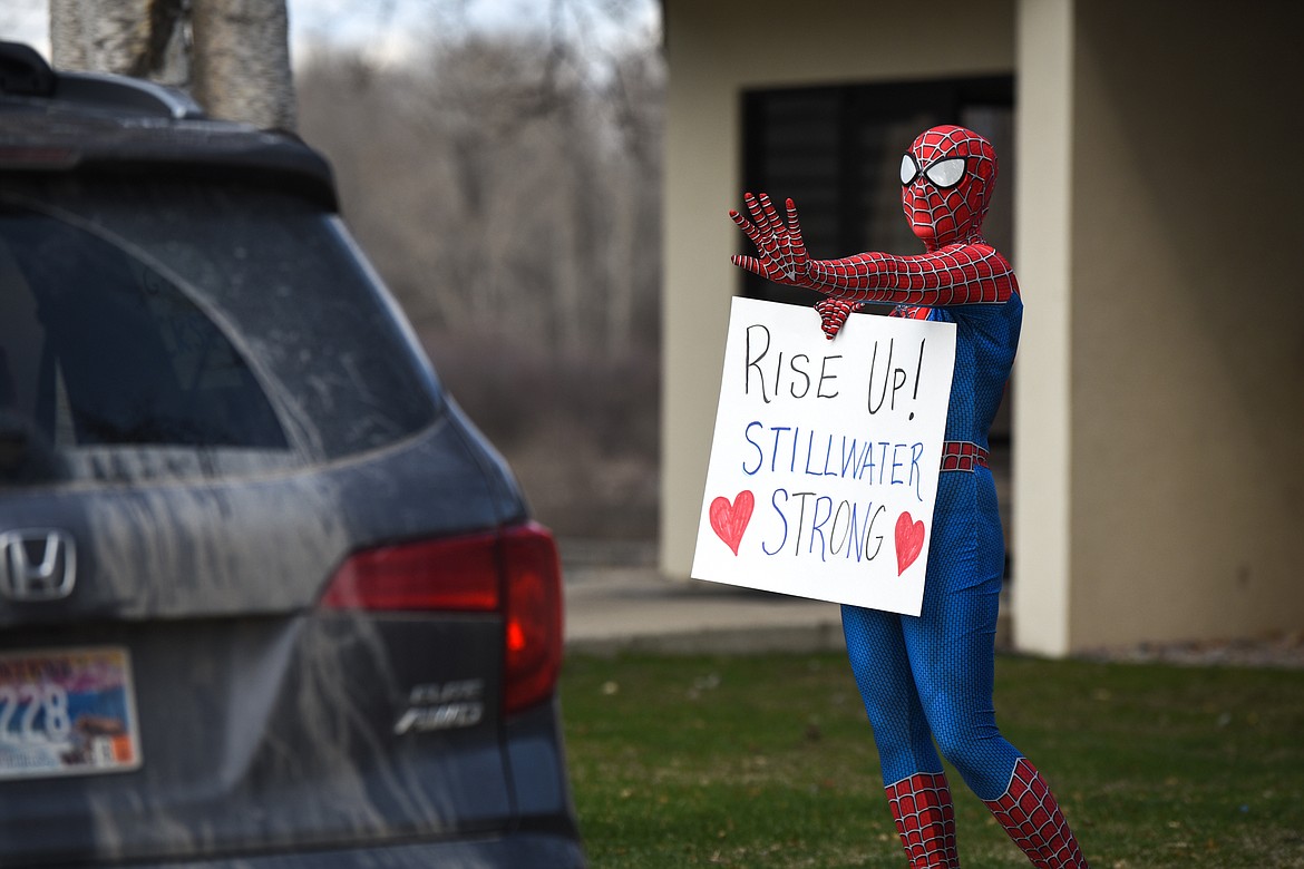 Stillwater Christian School second-grade teacher Jasmine Chase waves to students and parents while wearing a Spiderman costume during a parade for K-5 students and teachers outside the school on Friday, April 24. (Casey Kreider/Daily Inter Lake)