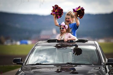 Students and parents wave to Stillwater Christian School staff members during a parade for grades K-5 outside the school on Friday, April 24. (Casey Kreider/Daily Inter Lake)