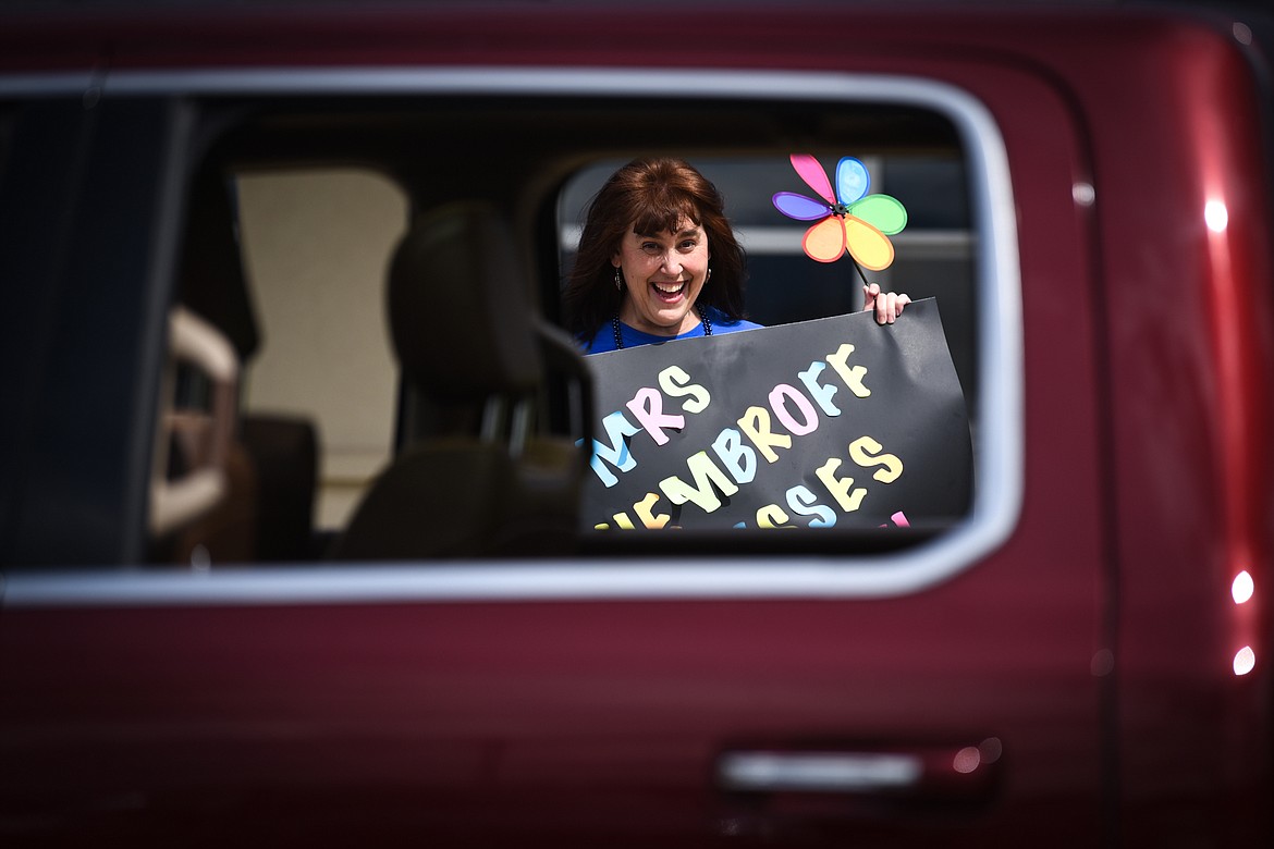 Stillwater Christian School kindergarten teacher Jill Hembroff waves and smiles to passing students and parents during a parade for grades K-5 outside the school on Friday, April 24. (Casey Kreider/Daily Inter Lake)