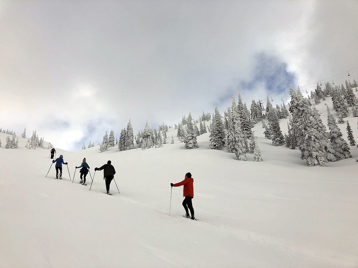 A group of snowshoers climb up Big Mountain on April 6. While Whitefish Mountain Resort closed for the season in mid-March due to COVID-19 concerns, many ambitious skiers and snowboarders have been “earning their turns” on Big Mountain. People are reminded to follow social-distancing guidelines while recreating during Gov. Steve Bullock’s stay-at-home order that expires April 24. (Matt Baldwin/Daily Inter Lake)