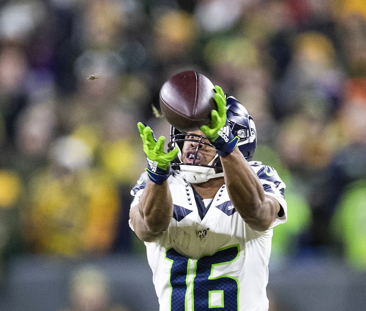 TNS 
 Seattle Seahawks wide receiver Tyler Lockett (16) catches a 28-yard pass from Seattle Seahawks quarterback Russell Wilson (3) during the first quarter against the Green Bay Packers on Sunday, Jan. 12, 2020 at Lambeau Field in Green Bay, Wis.