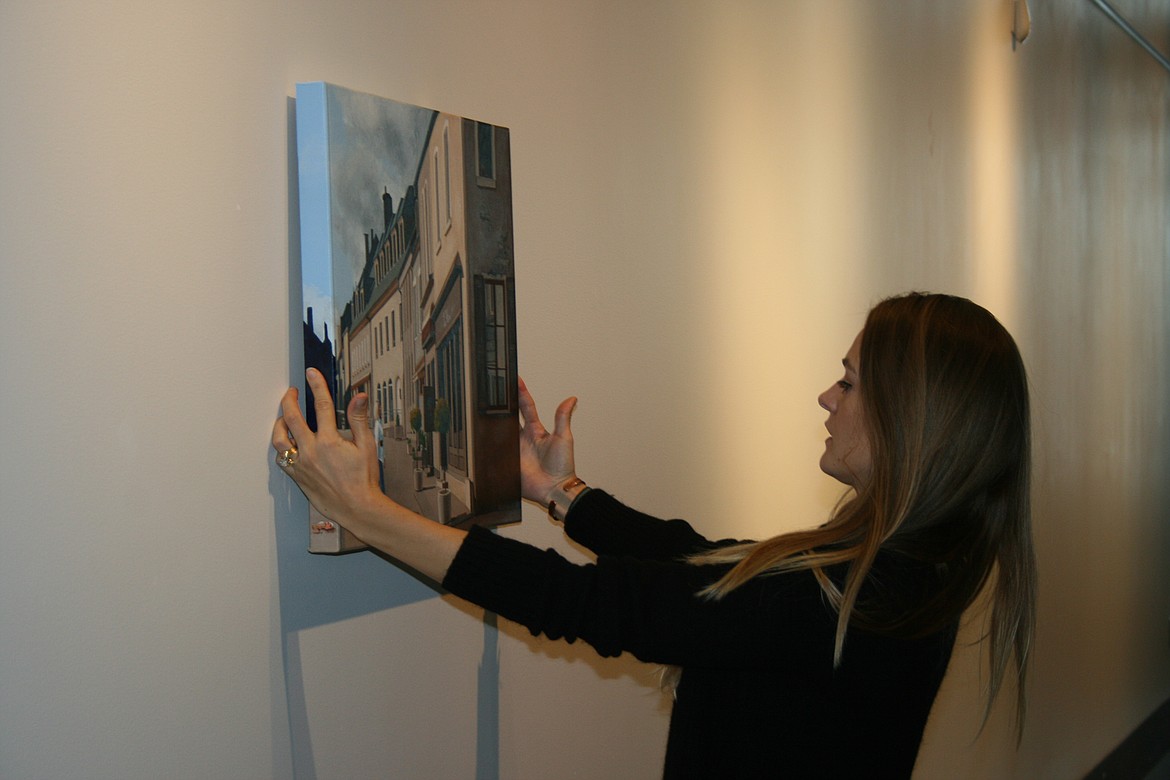 Moses Lake Museum & Art Center artistic director Erika Kovalenko experiments with a possible design for the “Uncorked” exhibit opening Friday at the museum.