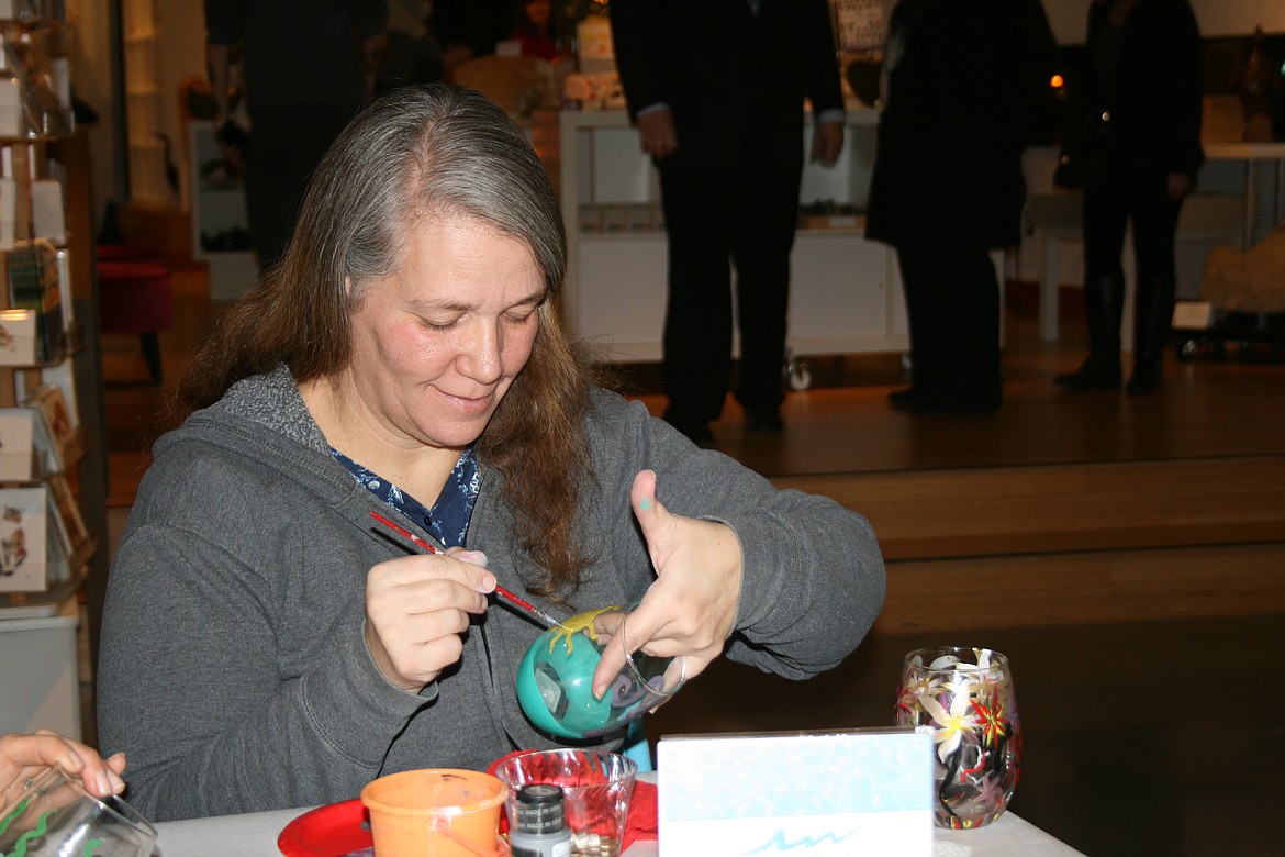Cheryl Schweizer/Columbia Basin Herald 
 Museum patrons had a chance to paint their own wineglass during the opening of the "Uncorked" exhibit at the Moses Lake Museum & Art Center Friday.