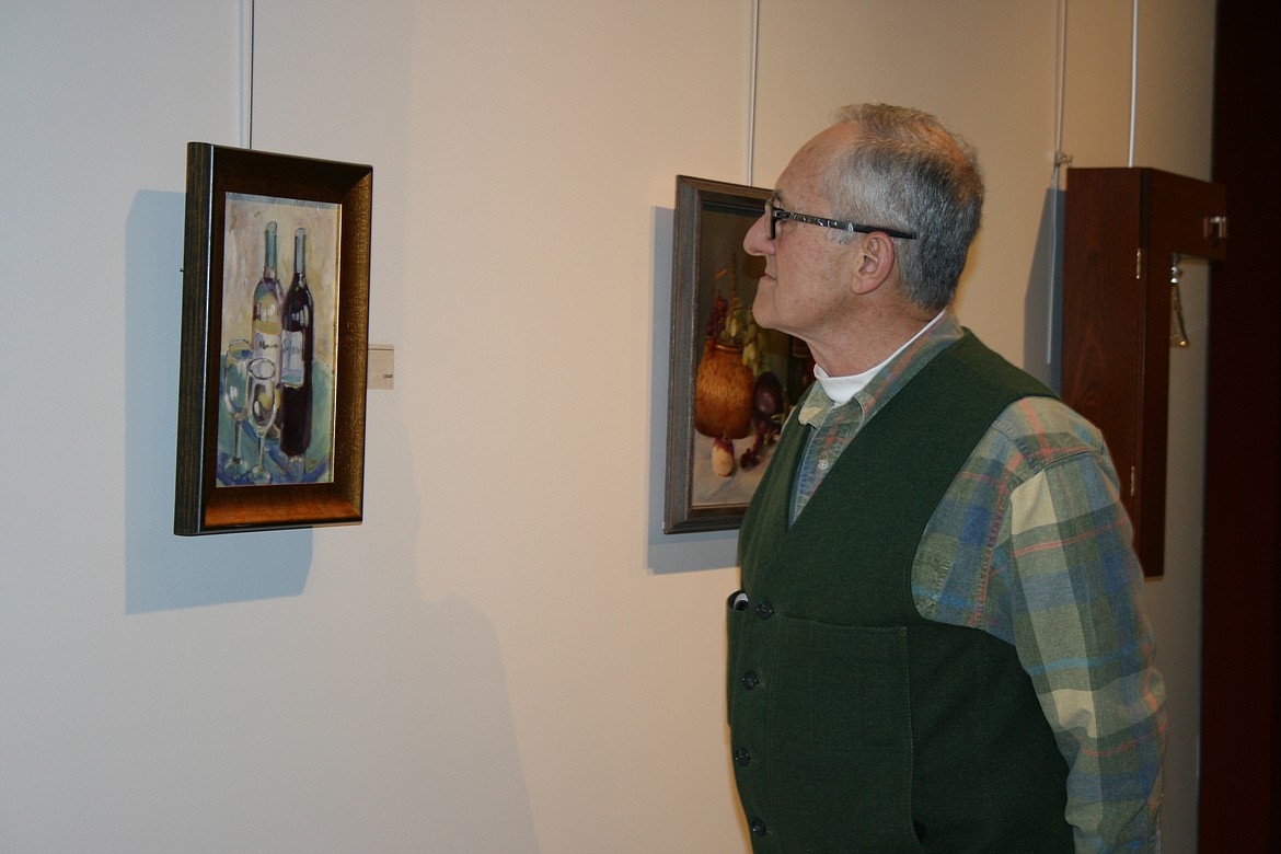Cheryl Schweizer/Columbia Basin Herald 
 Art lovers filled the Moses Lake Museum & Art Center Friday night for the opening of the wine-themed show “Uncorked.”