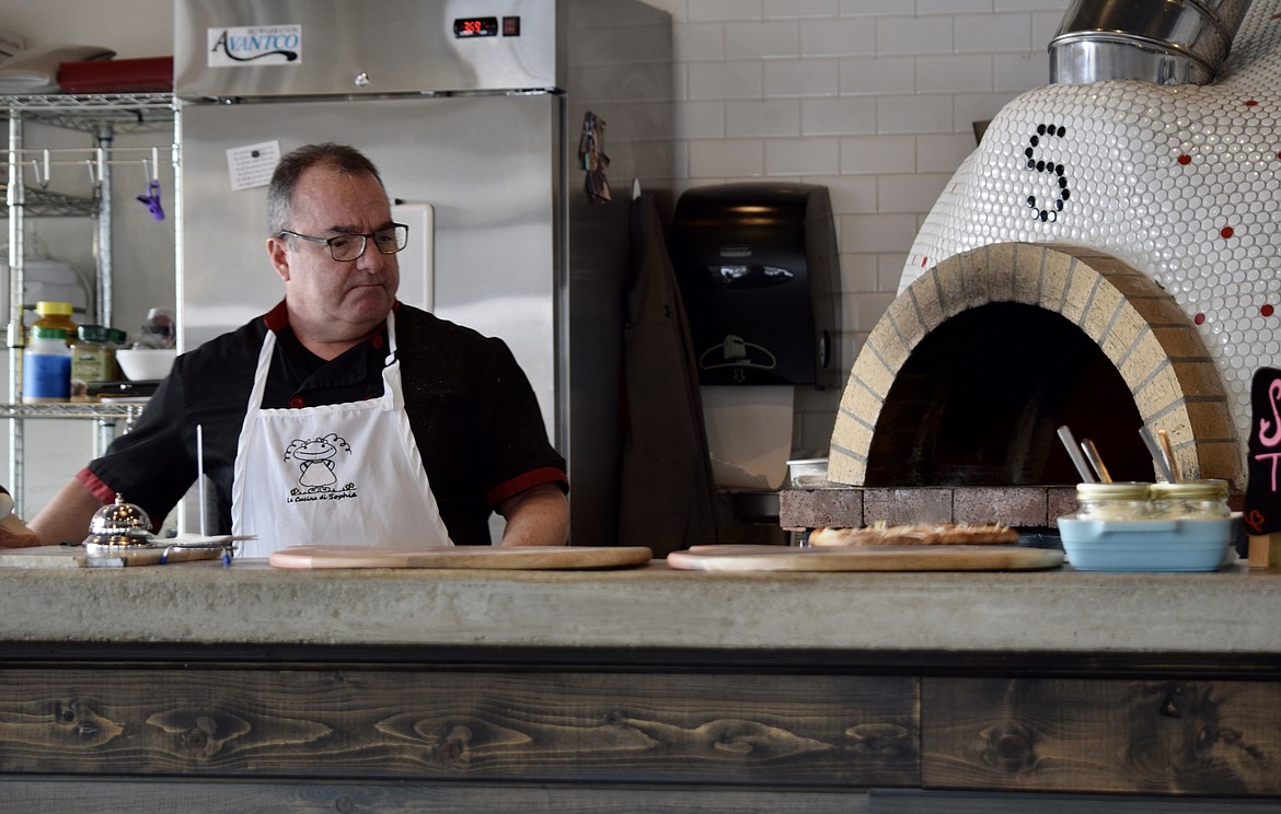 Azad Tarikian, owner of La Cucina di Sophia in Soap Lake, takes a pizza out of his wood-fired oven.