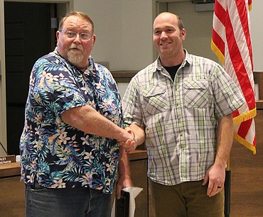 Quincy Mayor Paul Worley, left, shakes hands with David Durfee Jr. before giving him a plaque recognizing his four years serving on the Quincy City Council. Durfee didn’t run for re-election in November 2019 because he is building a house outside of the city limits. His seat on the council was taken by Dylan Kling.