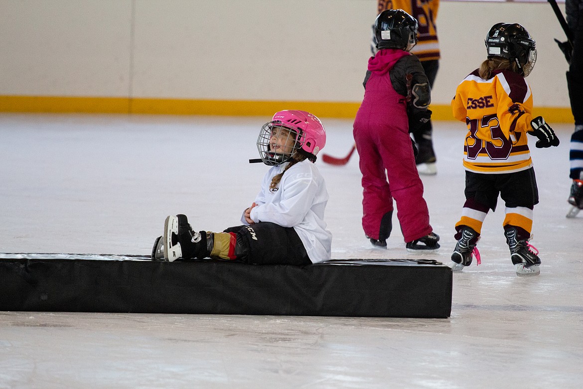 A young lady enjoys a break on the ice from the commotion at the Play Hockey Like a Girl event at Moses Lake Ice Rink on Monday.