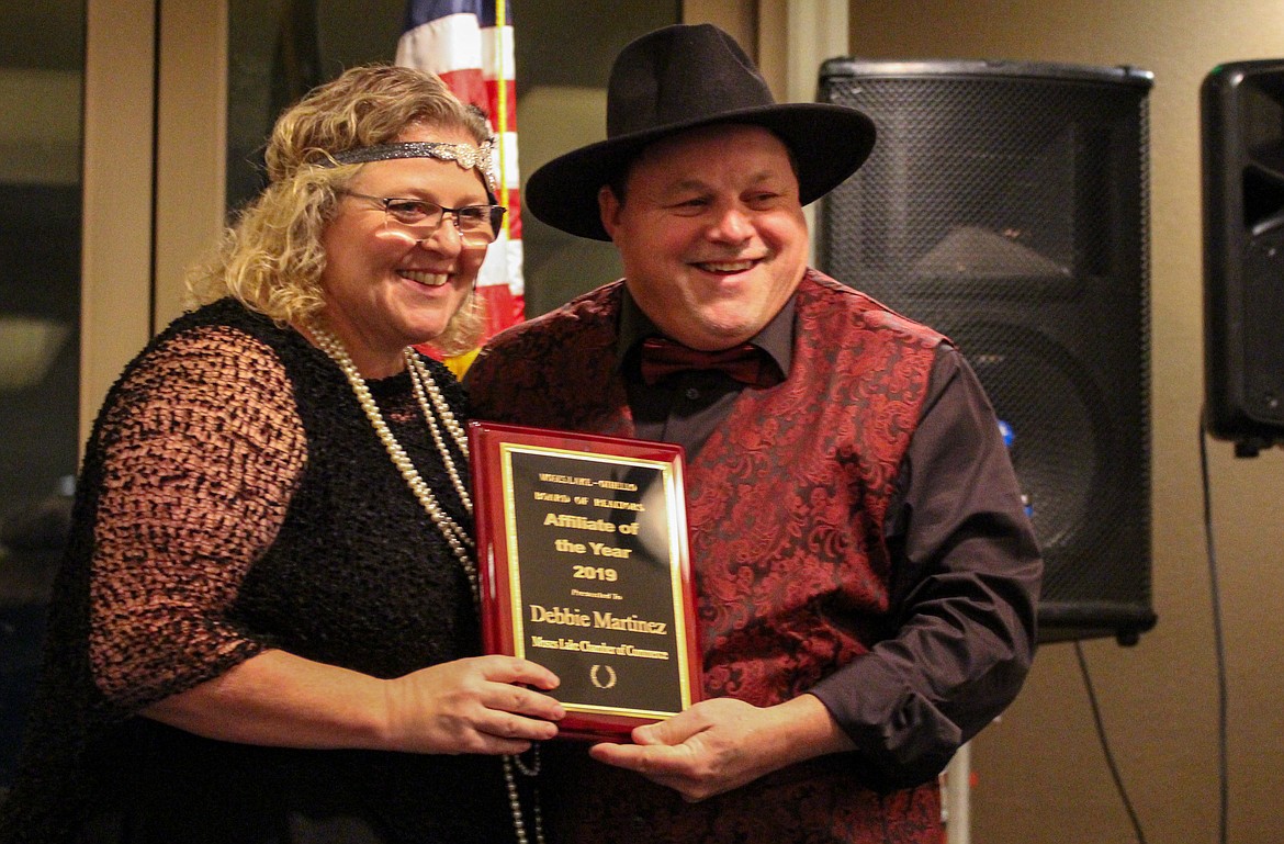 Outgoing President Doug Robins presents Debbie Doran-Martinez of the Moses Lake Chamber of Commerce with this year’s Affiliate of the Year Award at the Moses Lake-Othello Association of Realtors annual banquet on Saturday.