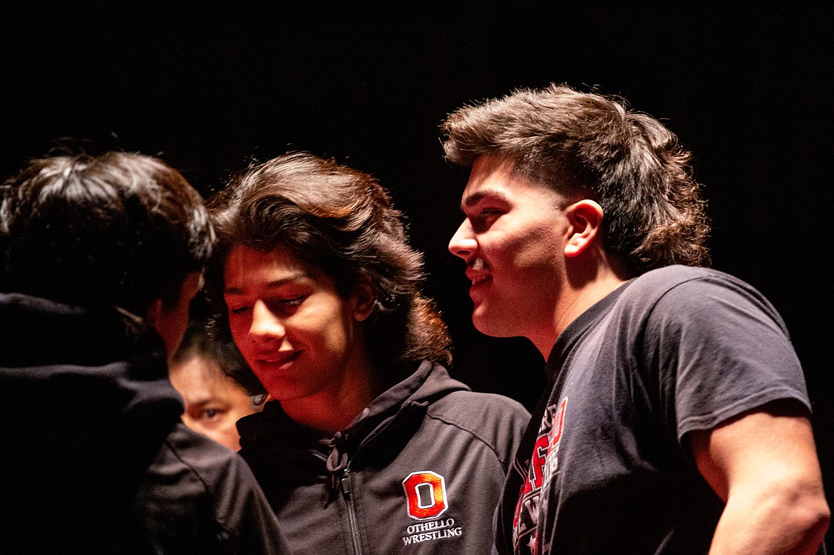 Isaiah Perez smiles as he talks with his teammates before his final home wrestling bout as an Othello Husky last Thursday.