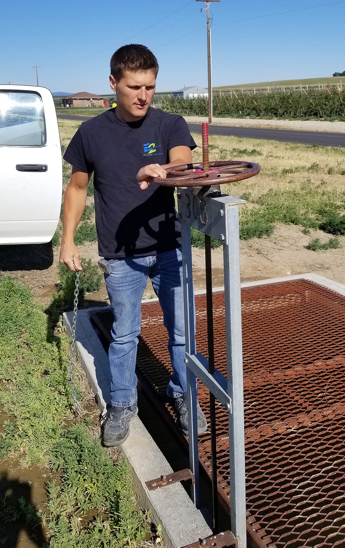 Nate Volkov adjusts the water for a farmer that is having back flooding issues.