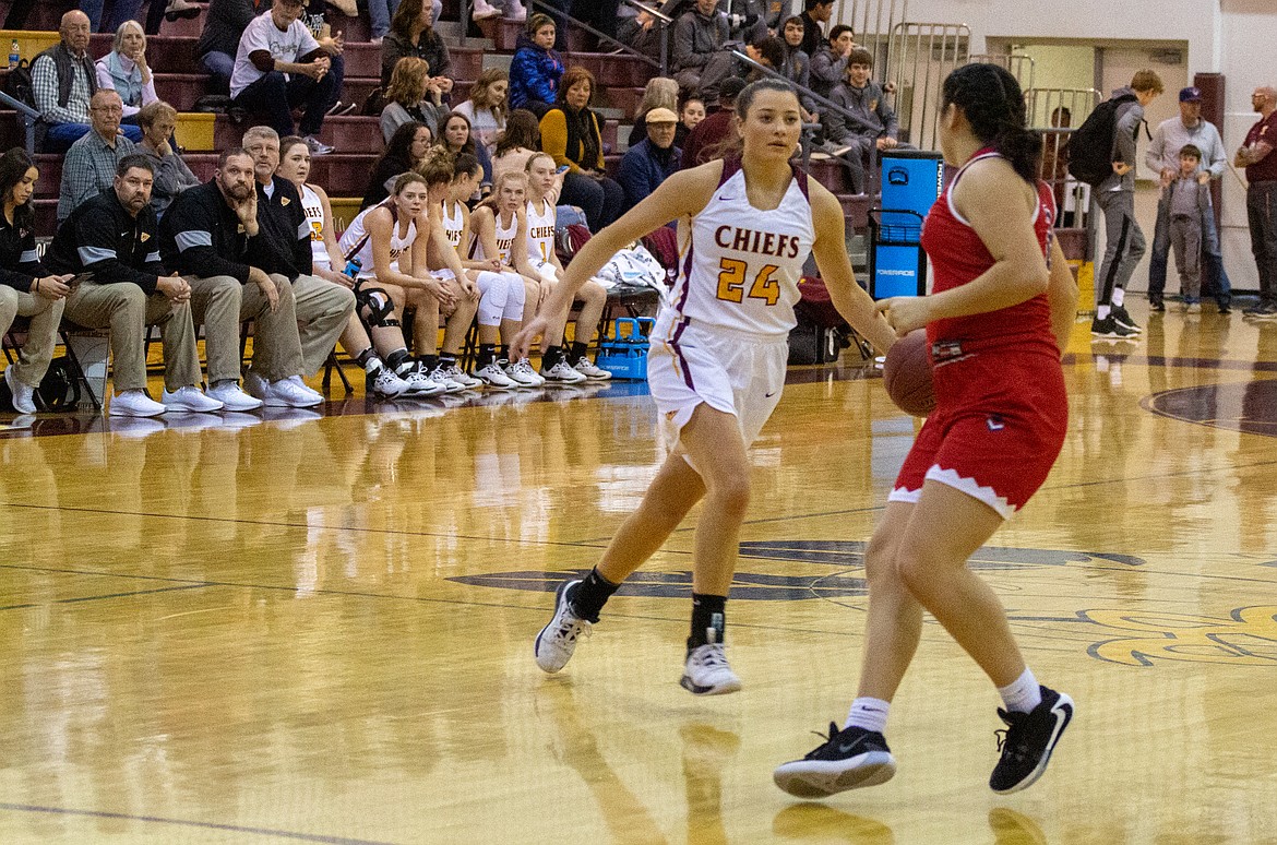 Casey McCarthy/Columbia Basin Herald Senior point guard Madisyn Clark surveys the defense as she comes up the floor in the Chiefs’ 72-32 win over Eisenhower on Saturday.