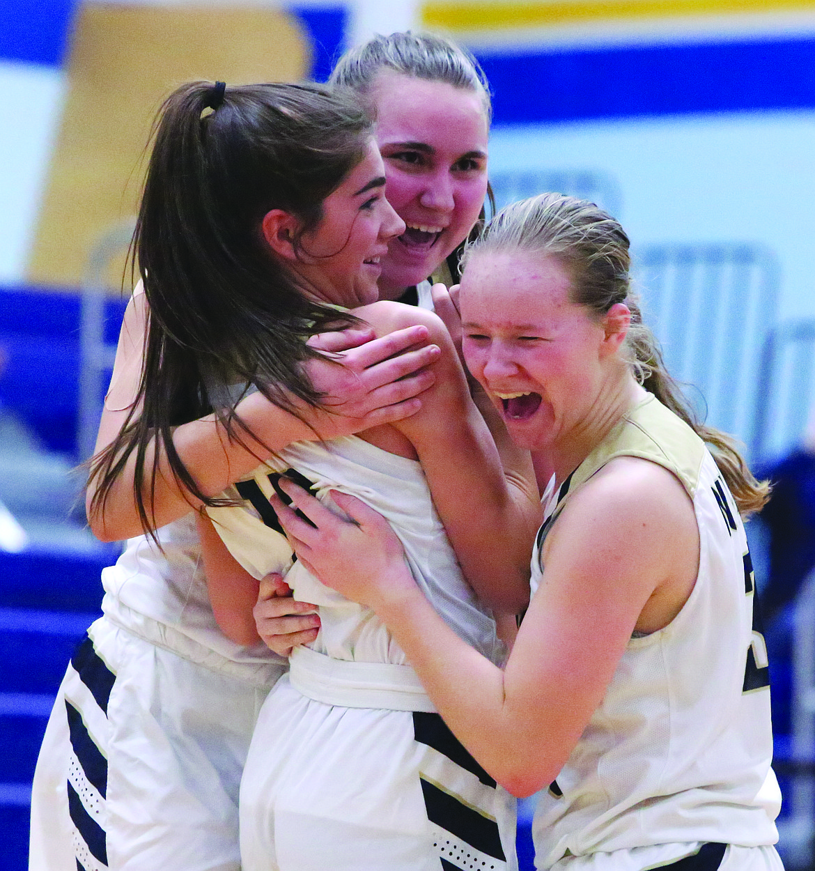 Connor Vanderweyst/Columbia Basin Herald 
 Moses Lake Christian sophomore Aspen Merkle (left) is congratulated by teammates Deana Gulenko (center) and Allison Stanley after scoring a buzzer-beating basket to beat Riverside Christian on Monday.