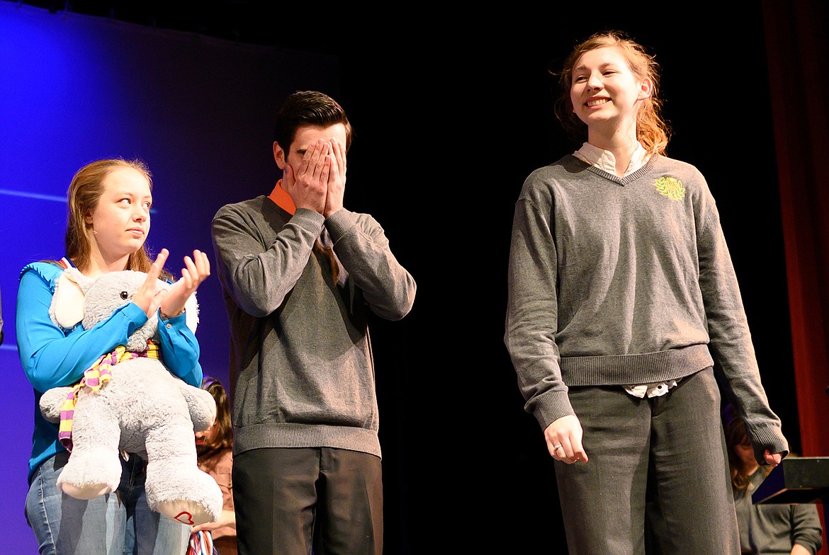 Whitefish’s Logan Mercer, center, reacts Saturday to being named the Class A state champion in humorous interpretation, while fellow Bulldog Eden Scrafford, right, reacts to earning the runner-up position at the Whitefish Performing Arts Center. (Chris Peterson/Hungry Horse News)