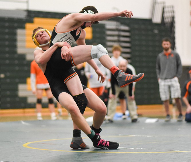 Rylee Creasey slams a Eureka wrestler during the Bulldogs’ home invitational last Friday. (Daniel McKay/Whitefish Pilot)