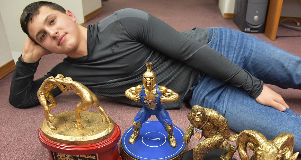 Jace DeShazer, 14, poses with a few of the trophies he has won wrestling in recent years. The Libby native and eighth grader wrestles at 149 pounds. (Duncan Adams/The Western News)