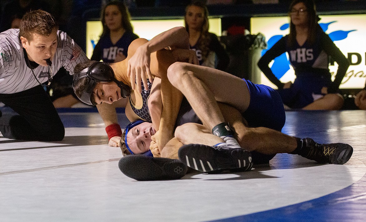 Casey McCarthy/Columbia Basin Herald Royal’s Dominic Martinez works for the pin against Warden’s Brenton Cole in the championship round at 132 at the SCAC East district boys wrestling tournament on Saturday afternoon.