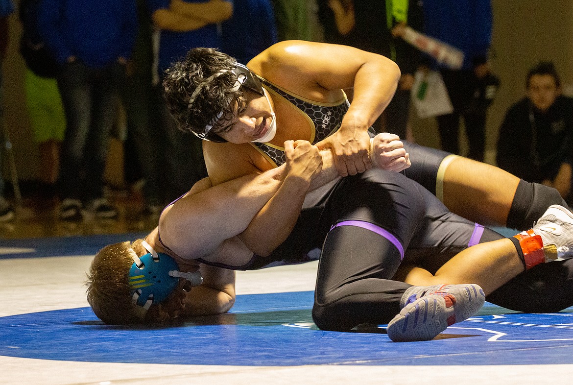 Casey McCarthy/Columbia Basin Herald Royal’s Benji Bustos clings to the arm of Connell’s Jekoby Tuttle as he looks to maintain his lead before taking the finals match at 170 with the 6-0 decision.