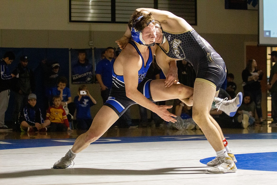 Casey McCarthy/Columbia Basin Herald Kaleb Hernandez of Royal grabs the leg of his opponent from Kiona-Benton as he looks to take him to the ground in the finals round at 145 on Saturday afternoon.