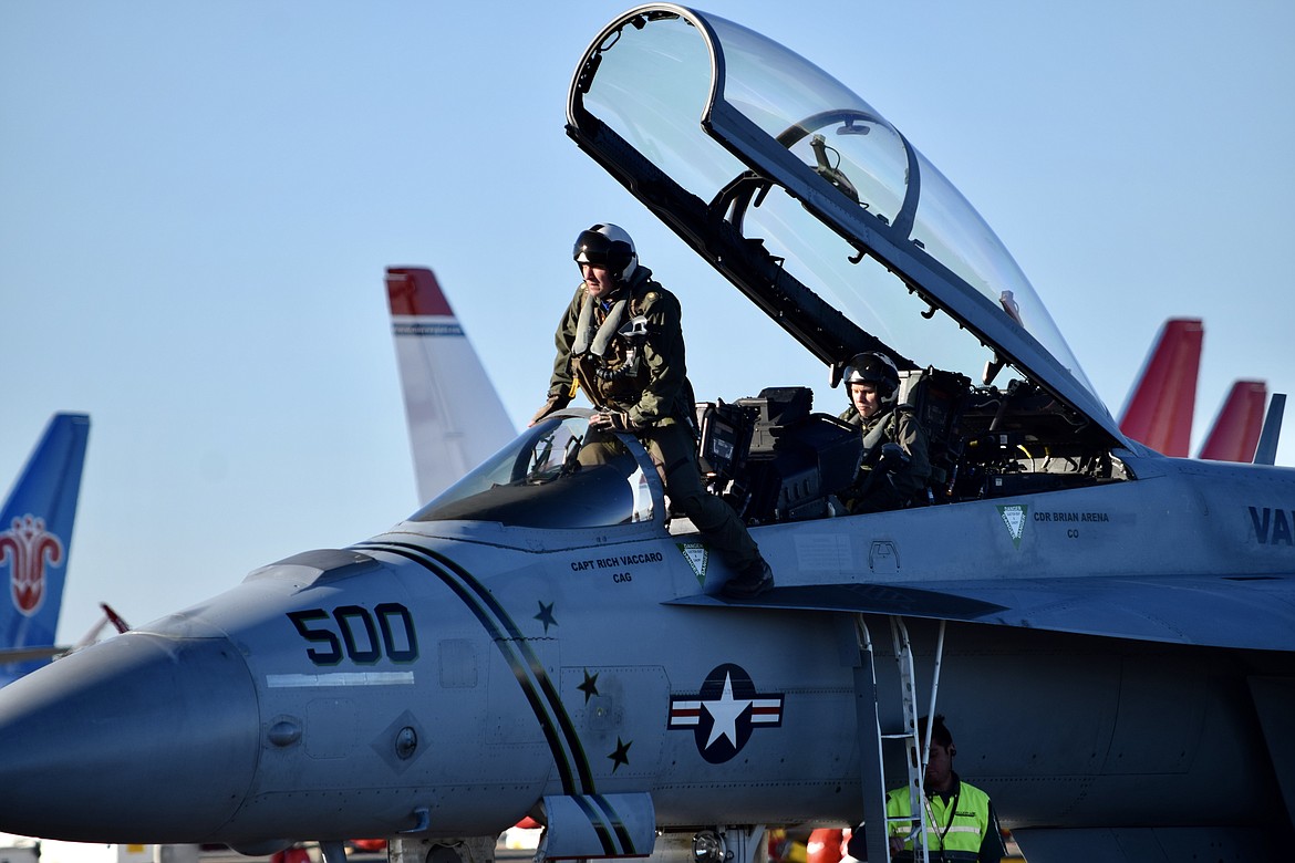 Charles H. Featherstone/Columbia Basin Herald 
 Two U.S. Navy Reserve pilots climb into their EA-18G Growler airplane at the Grant County International Airport Monday afternoon after taking a break in-between training flights.