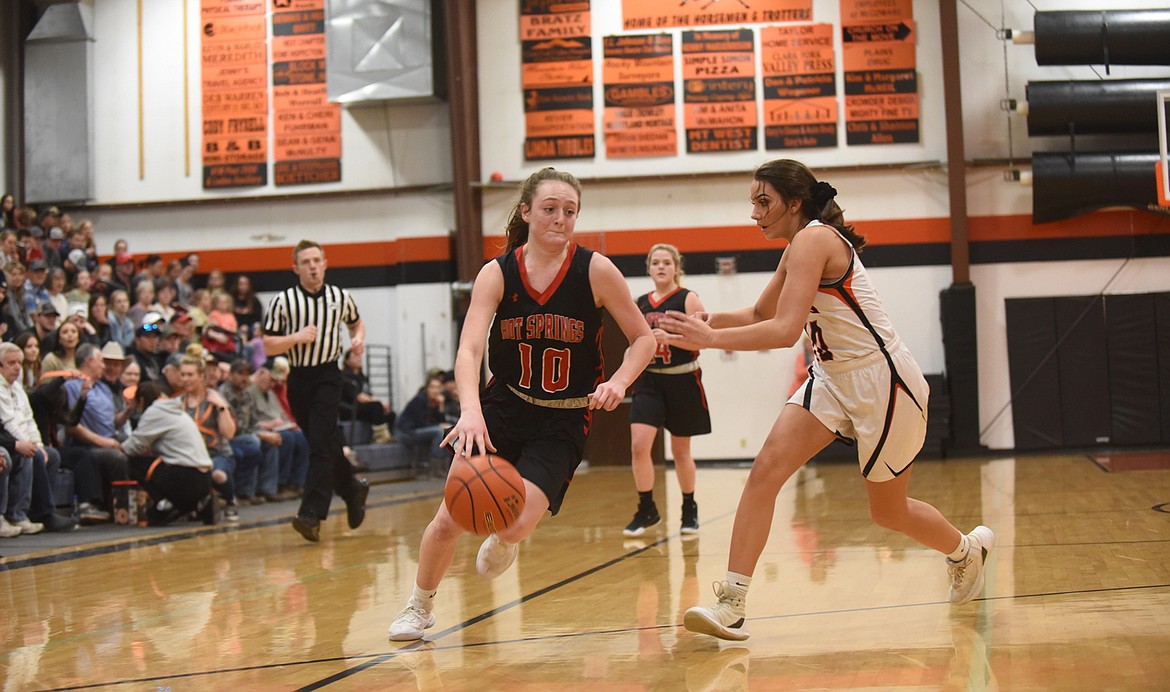 Hot Springs sophomore Katelyn Christensen (10) drives to the basket despite the defense of Plains senior Miera Loberg. (Scott Shindledecker/Valley Press)