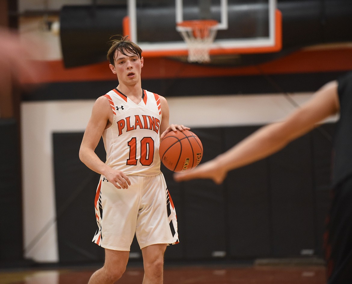 Plains senior Treydon Brouillette (10) dribbles upcourt against Hot Springs in a Feb. 6 game against Hot Springs. He scored 21 points to lead the Horsemen to a win. (Scott Shindledecker/Valley Press)