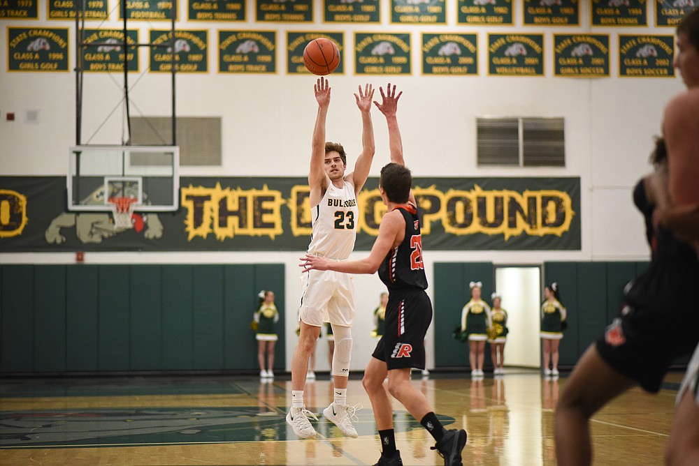 Justin Conklin launches a three during the Bulldogs' home loss last Tuesday. (Daniel McKay/Whitefish Pilot)