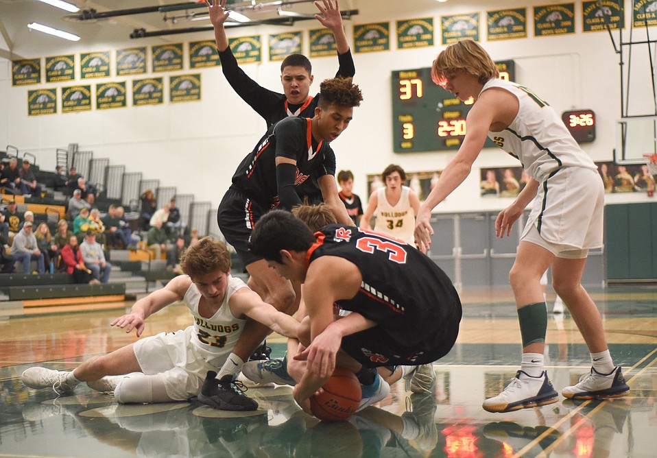 Justin Conklin dives for a loose ball during the Bulldogs' home loss last Tuesday. (Daniel McKay/Whitefish Pilot)