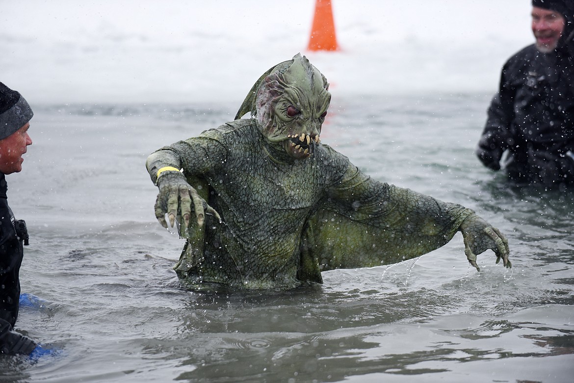 A jumper emerges from Whitefish Lake Saturday morning during the annual Penguin Plunge at City Beach. The event raises money for Special Olympics Montana. (Heidi Desch/Whitefish Pilot)