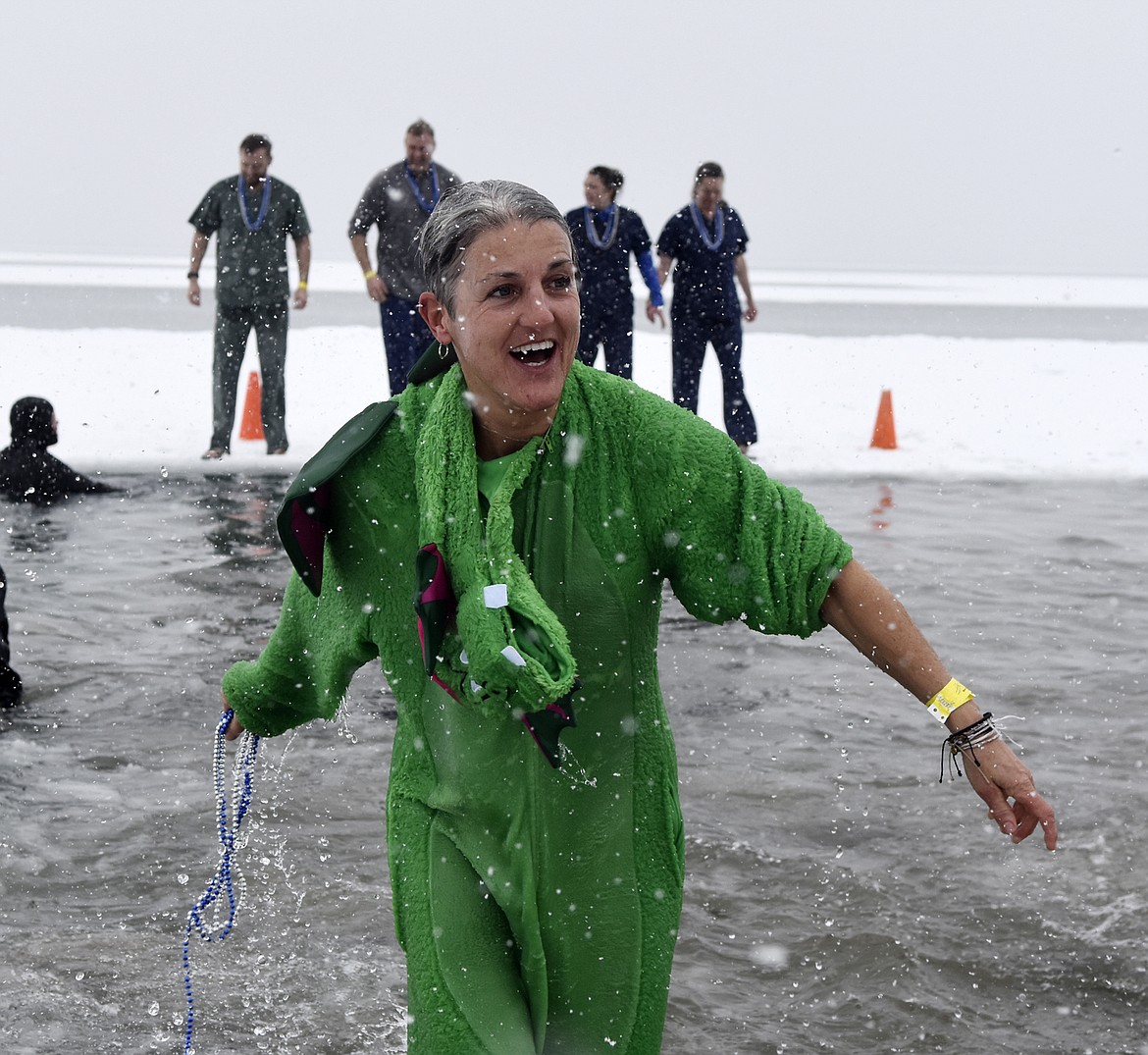 A participant from the North Valley Hospital team emerges from Whitefish Lake Saturday morning during the annual Penguin Plunge at City Beach. (Heidi Desch/Whitefish Pilot)