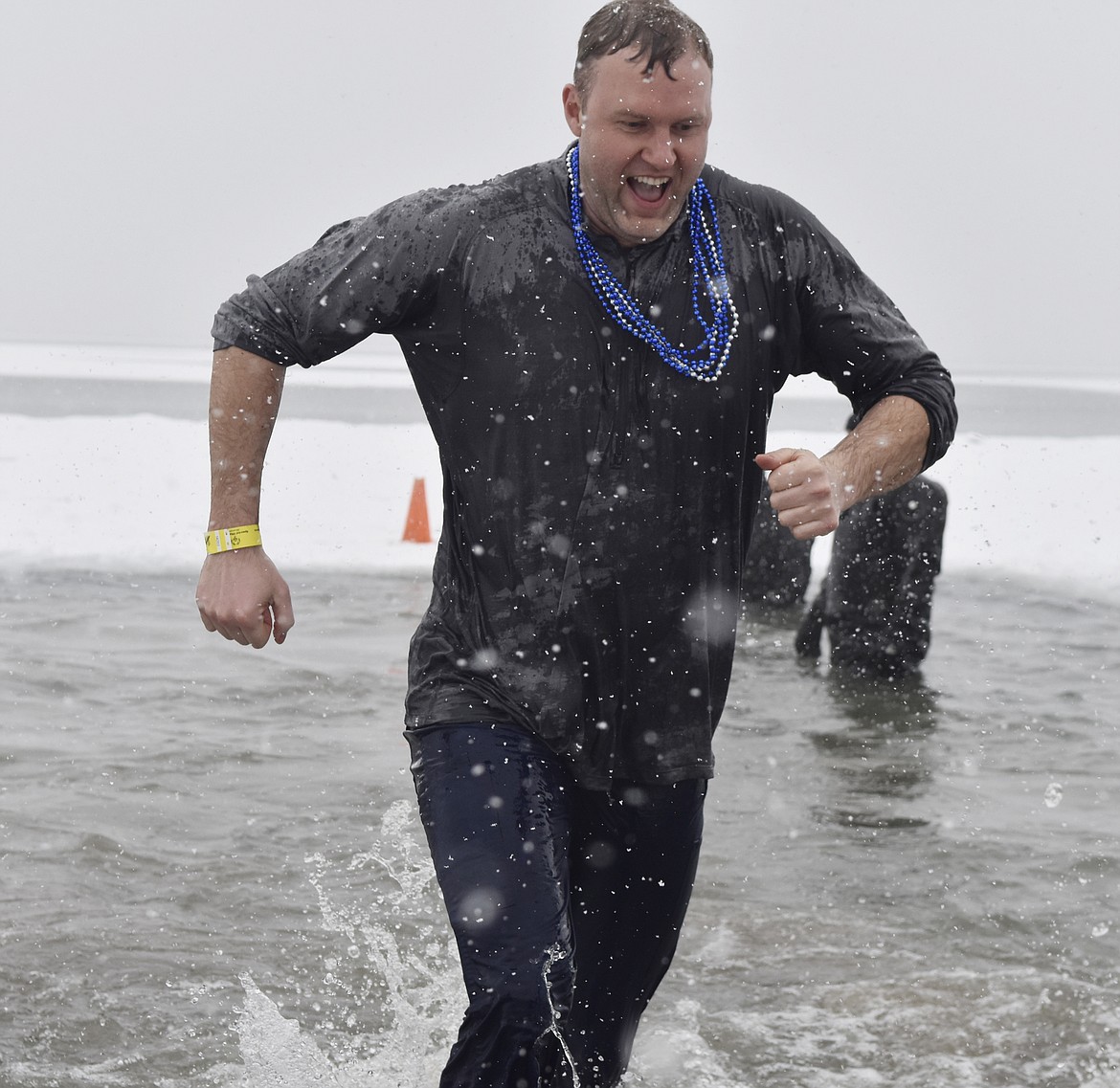 A group jumps into Whitefish Lake Saturday morning during the annual Penguin Plunge at City Beach. The event raises money for Special Olympics Montana. (Heidi Desch/Whitefish Pilot)