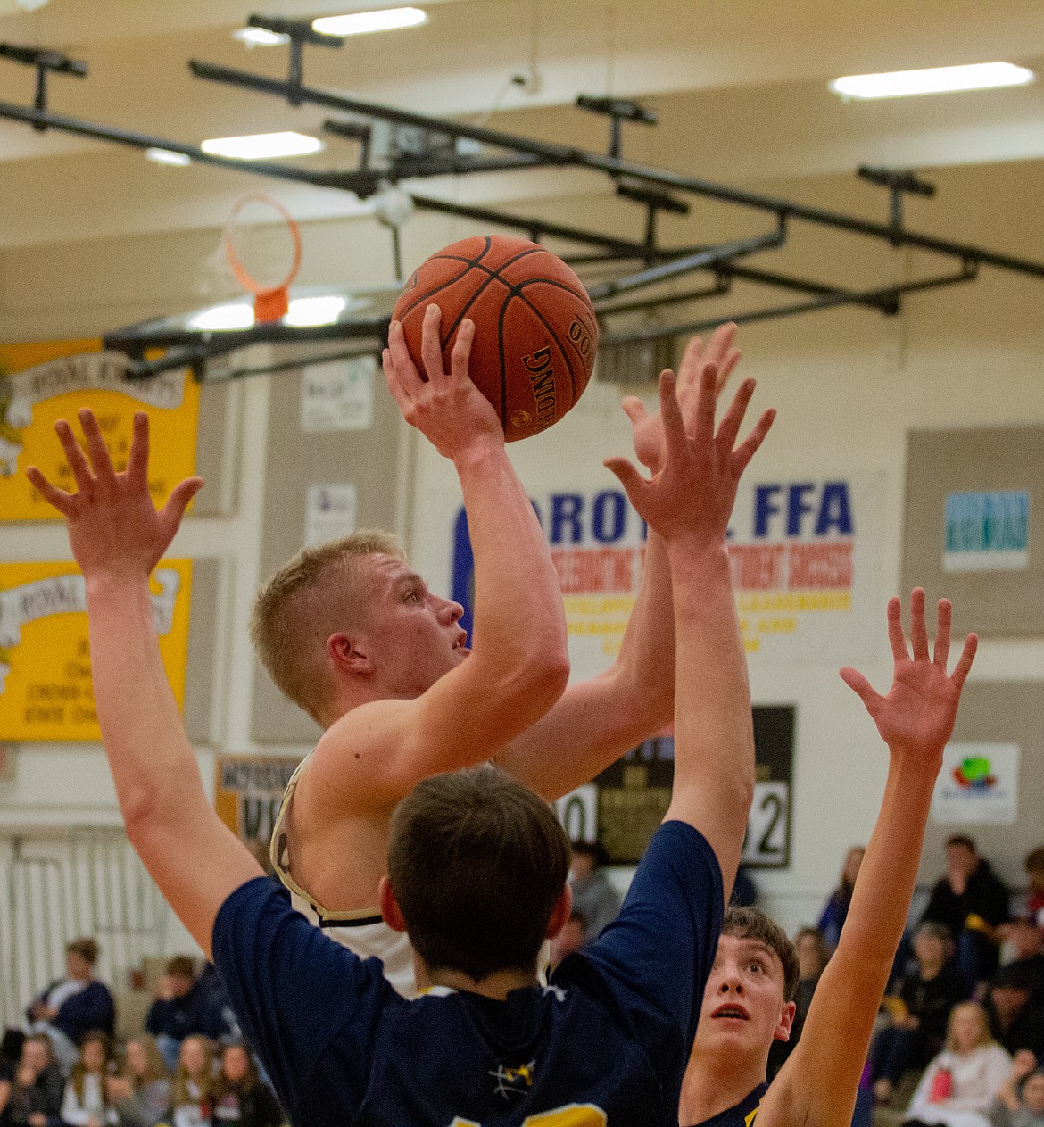 Casey McCarthy/Columbia Basin Herald Derek Bergeson takes the shot in the lane between a pair of Rangers in the second half of Royal’s win in the opener of the SCAC District tournament for the Knights.