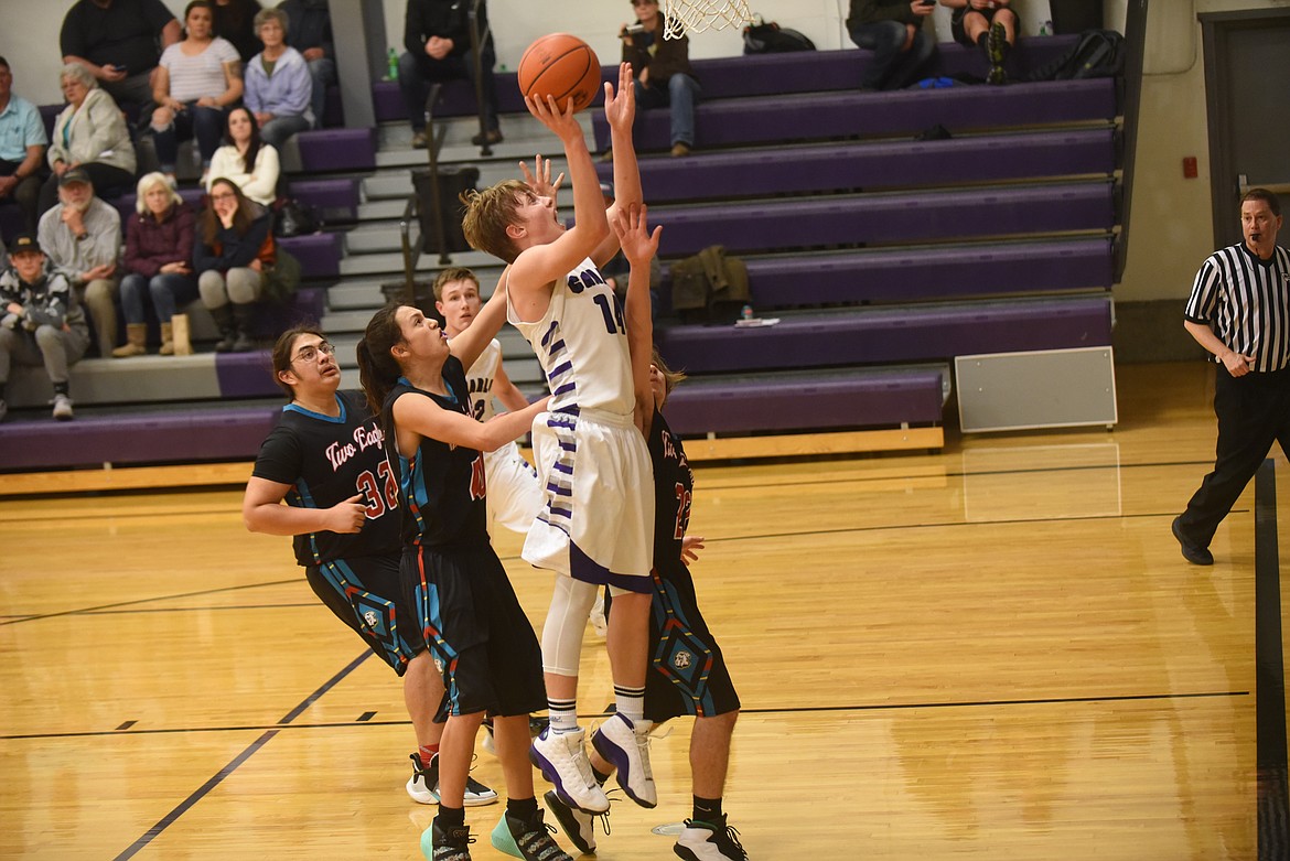 Charlo’s Dawson DuMont goes against a number of Two Eagle River defenders in Friday’s game. DuMont scored 26 points in a 58-37 win. (Scott Shindledecker/Lake County Leader)