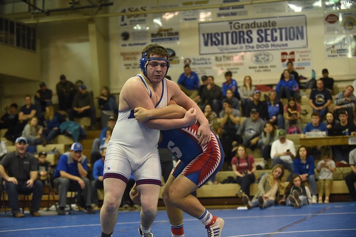 Mission-Charlo’s Miles Anderson works to get out of the grasp of Clark Fork’s Chandon Vulles during their finals match at 205 pounds last Saturday at the Class B-C Western Division tournament in St. Ignatius. Anderson pinned Vulles in 3:53. (Scott Shindledecker/Lake County Leader)