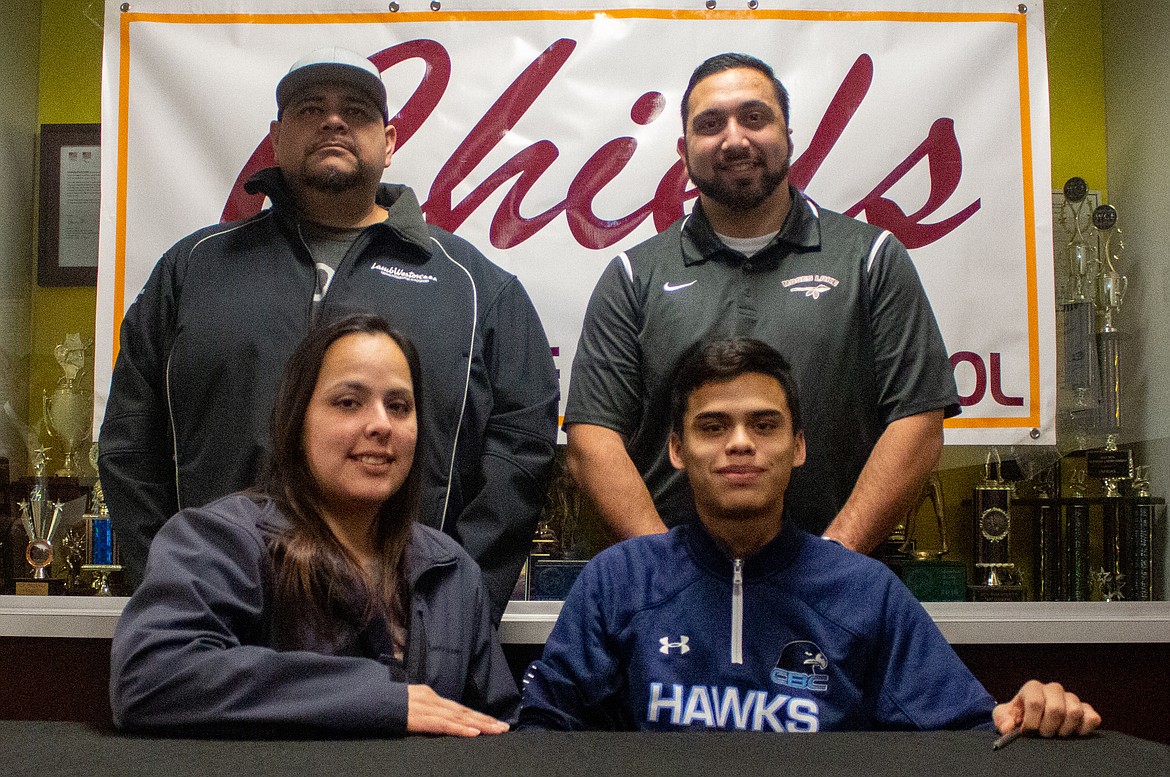 Moses Lake senior Raymundo Curiel, his parents, and former Moses Lake head coach Richie Ramirez celebrate as Curiel extends his soccer career by signing with Columbia Basin College for next season.