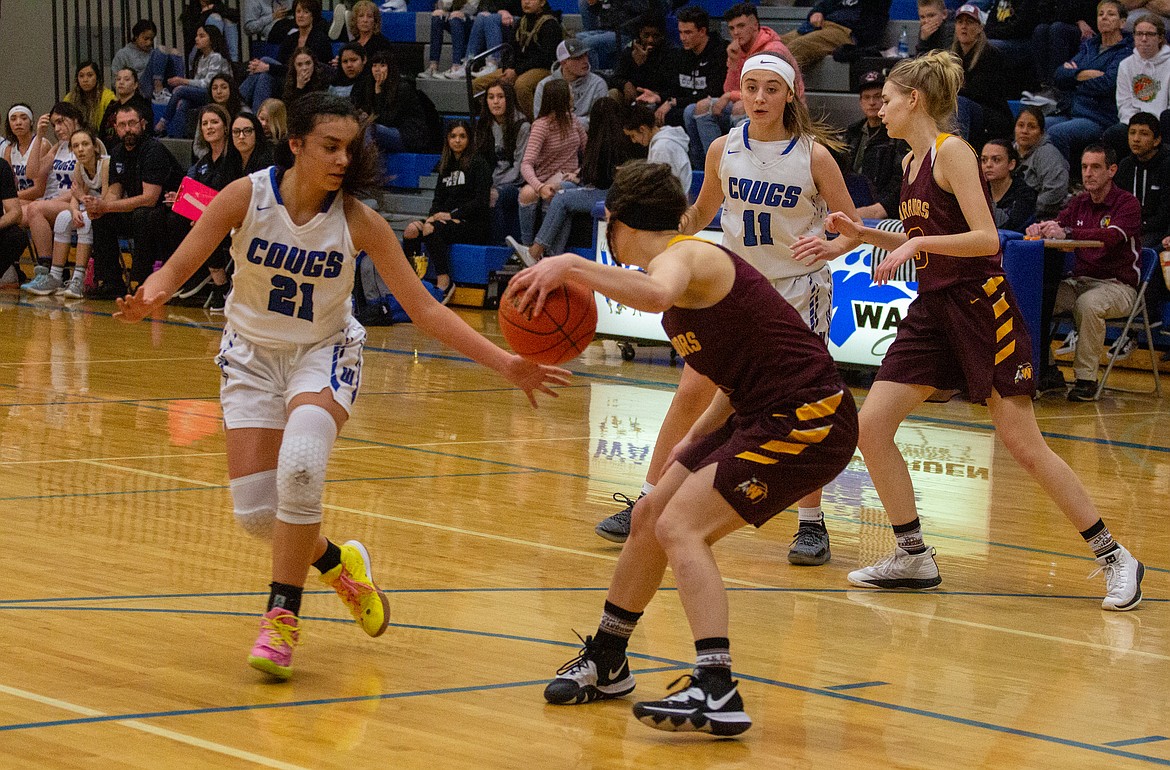 Casey McCarthy/Columbia Basin Herald Jlynn Rios goes in for the steal against the Cle Elum guard in the first half of the 64-32 win for the Cougars.