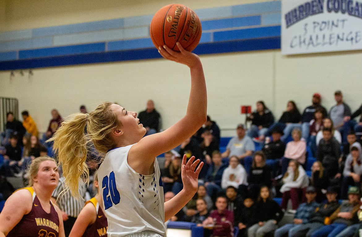 Casey McCarthy/Columbia Basin Herald Jaryn Madsen drives in for the scoop and score under the basket in the first half of Warden’s victory over Cle Elum/Roslyn to open SCAC district play for the Cougars.