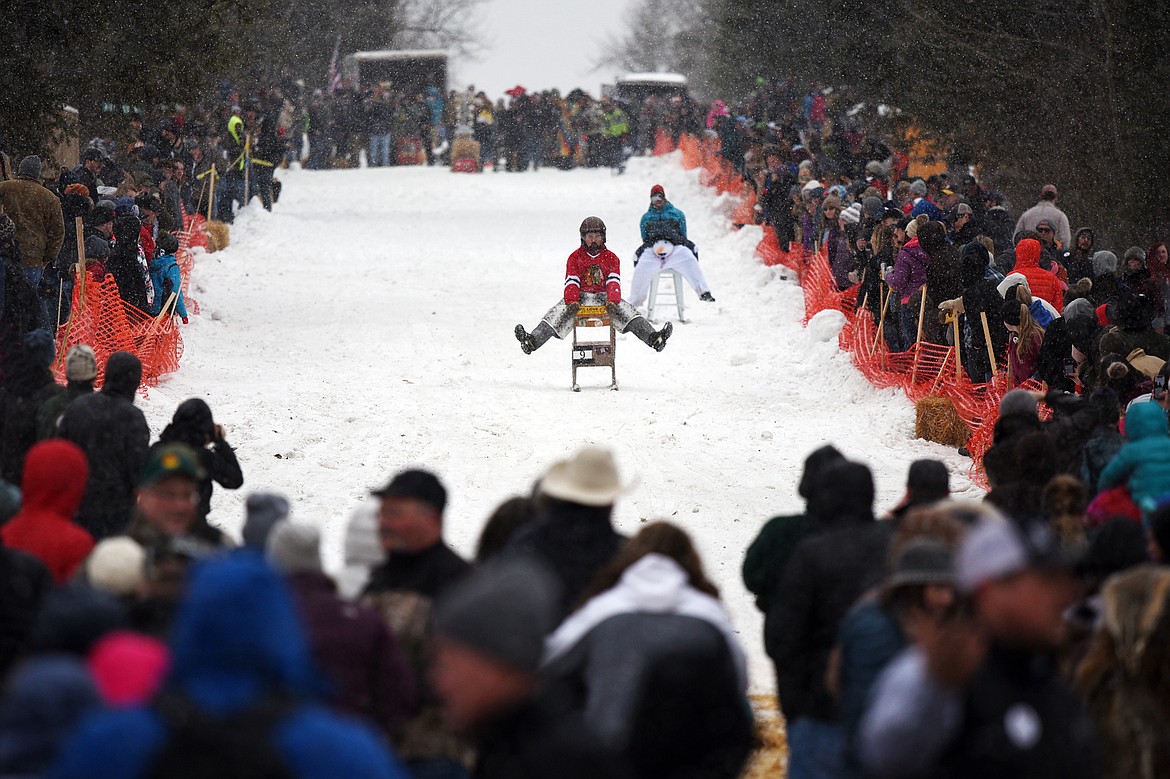 Participants race down Sugar Hill during the Barstool Ski Races at Cabin Fever Days in Martin City on Saturday, Feb. 15. (Casey Kreider/Daily Inter Lake)