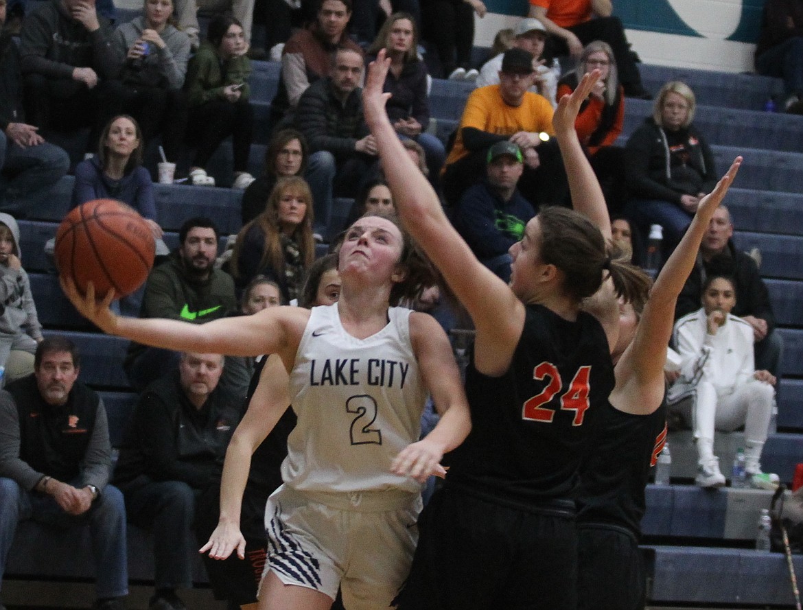 JASON ELLIOTT/Press
Lake City junior guard Jaya Miller drives to the basket on Post Falls freshman Capri Sims during Saturday’s 5A Region 1 girls basketball tournament second-place game at Lake City 