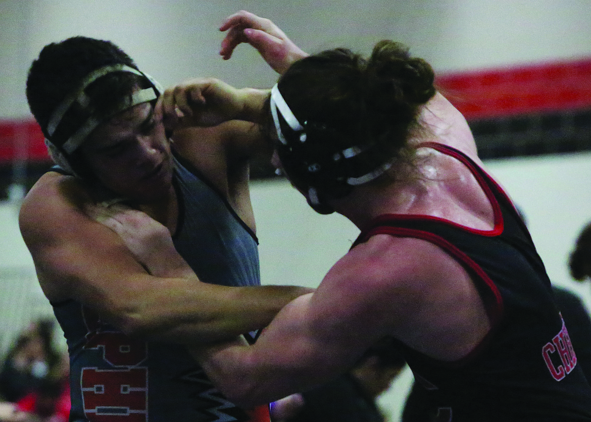 Connor Vanderweyst/Columbia Basin Herald 
 Quincy’s Mykenzi Realme (left) grapples with Cheney’s Anthony Aguilera during the consolation finals of the 170-pound division at the 2A Region IV tournament at Cheney High School. Realme placed fourth and qualified for this weekend’s Mat Classic.