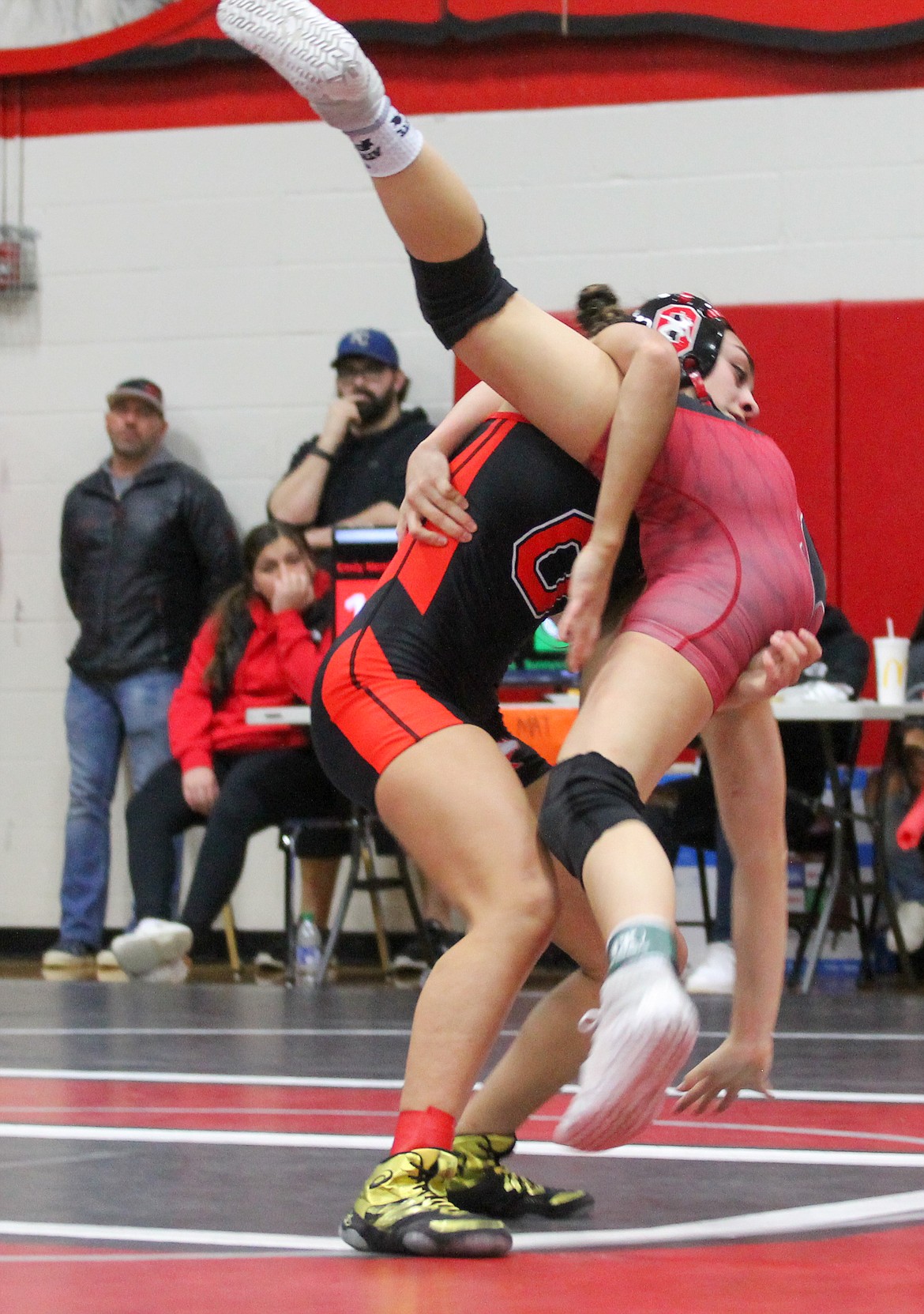 Casey McCarthy/Columbia Basin Herald Othello’s Emily Mendez picks up her opponent from Sunnyside before slamming her to the mat on Saturday at the Region IV girls tournament.