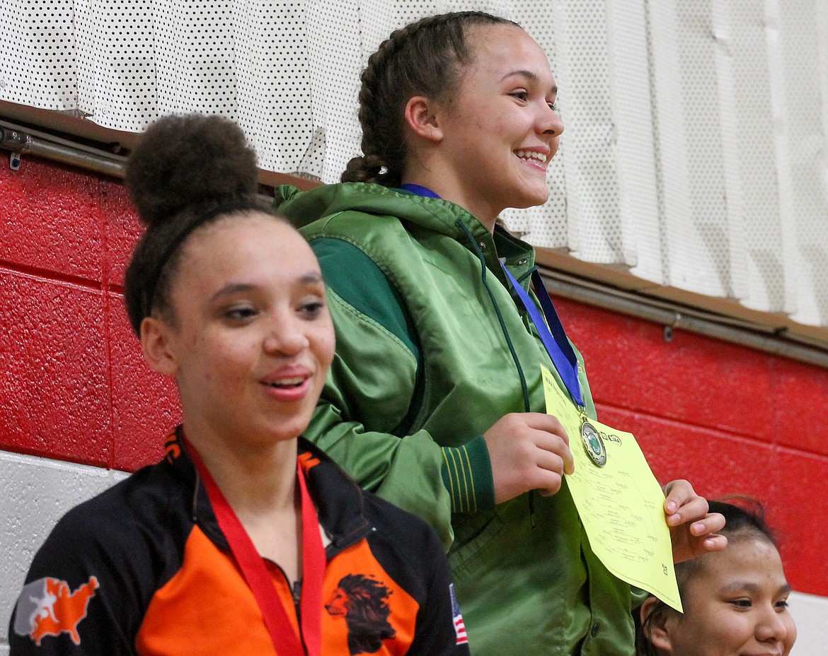 Quincy’s Shannon “Ducky” Workinger grins after receiving her medal for her first-place finish in the 155 weight class at the Region IV girls tournament in Othello.