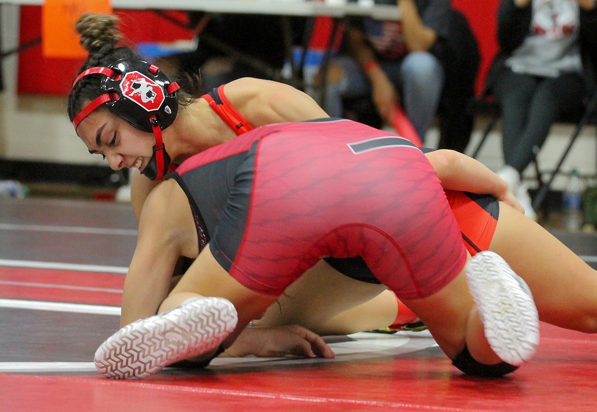 Casey McCarthy/Columbia Basin Herald Othello senior Emily Mendez works to secure position against Sunnyside’s Alexxus Ramos in the finals of the 110 division.