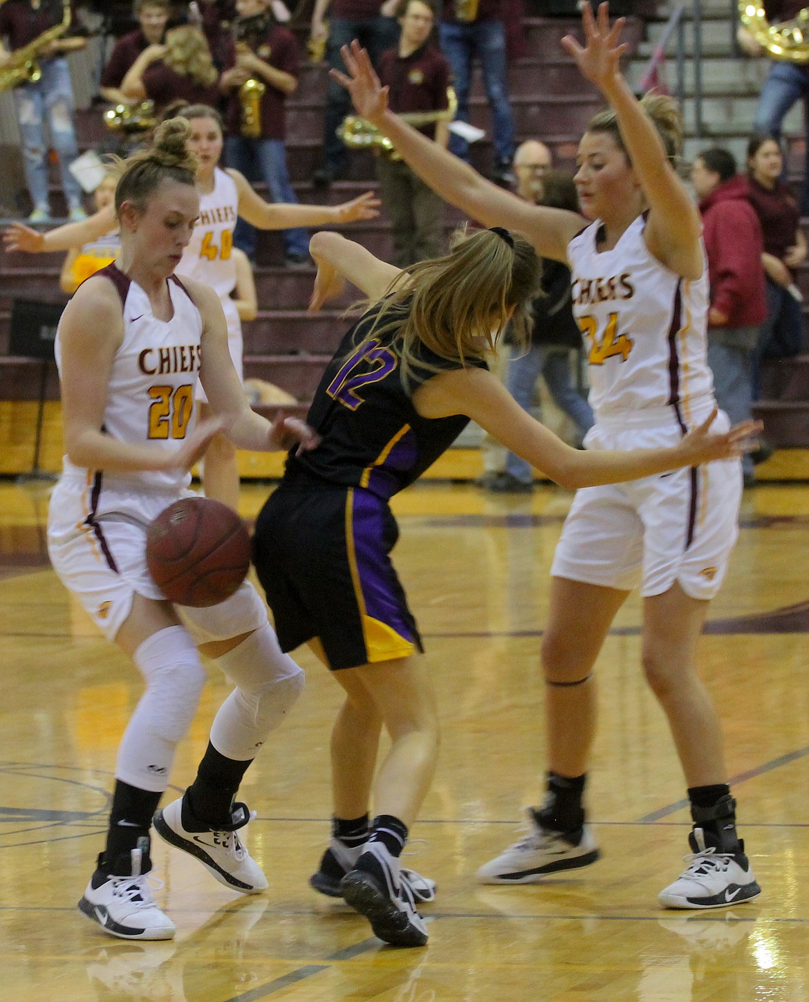 Camille Carpenter (left) rips the ball away from the Wenatchee guard as she and Madisyn Clark form the trap at midcourt on Friday night.