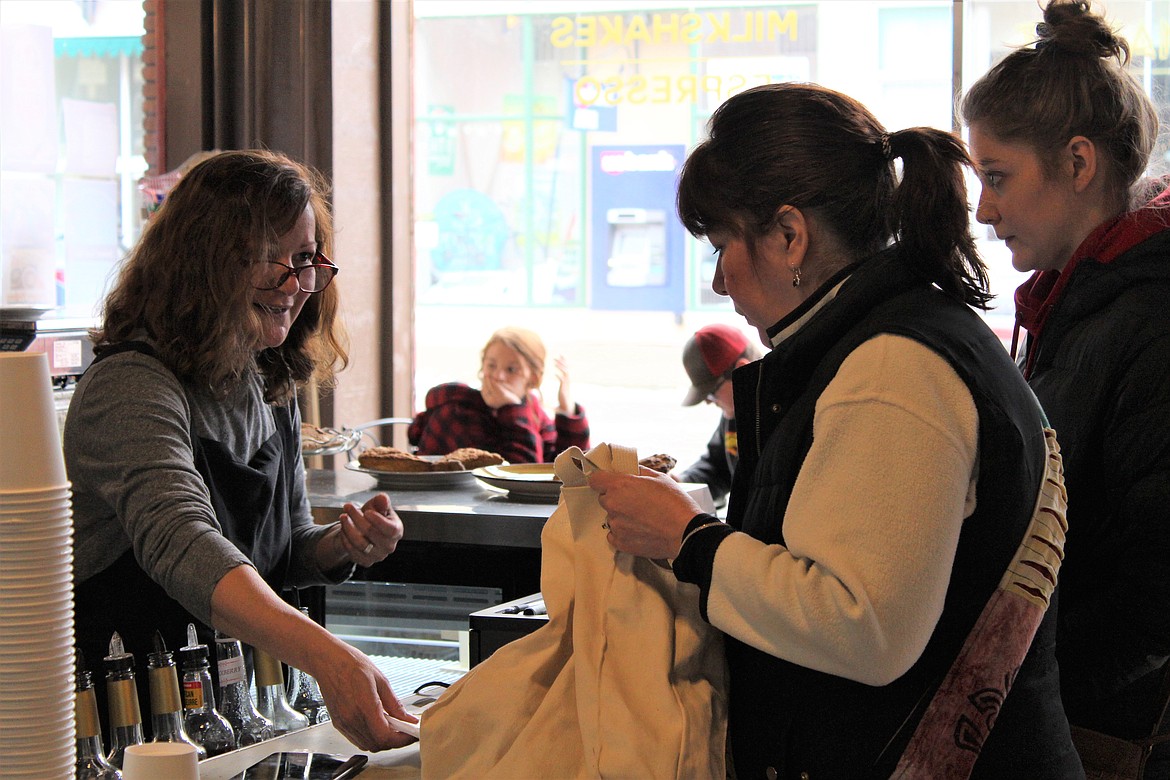 Luanne Wuerfel helps some customers in the coffee shop during an especially busy SkiJor weekend.