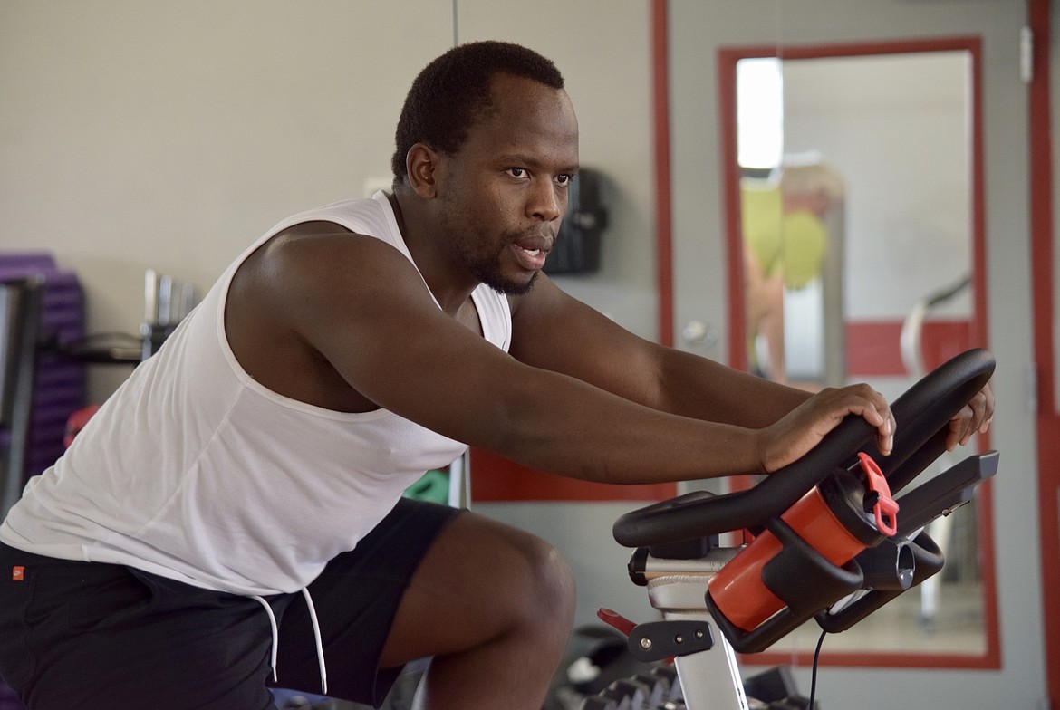 Evolve Fitness trainer Sip Mbolekwa leads a stationary cycling class.