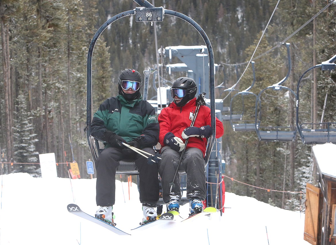 Jeff Kemp and Tom Edge ride the Thunderhead lift to the top of Blacktail Mountain.